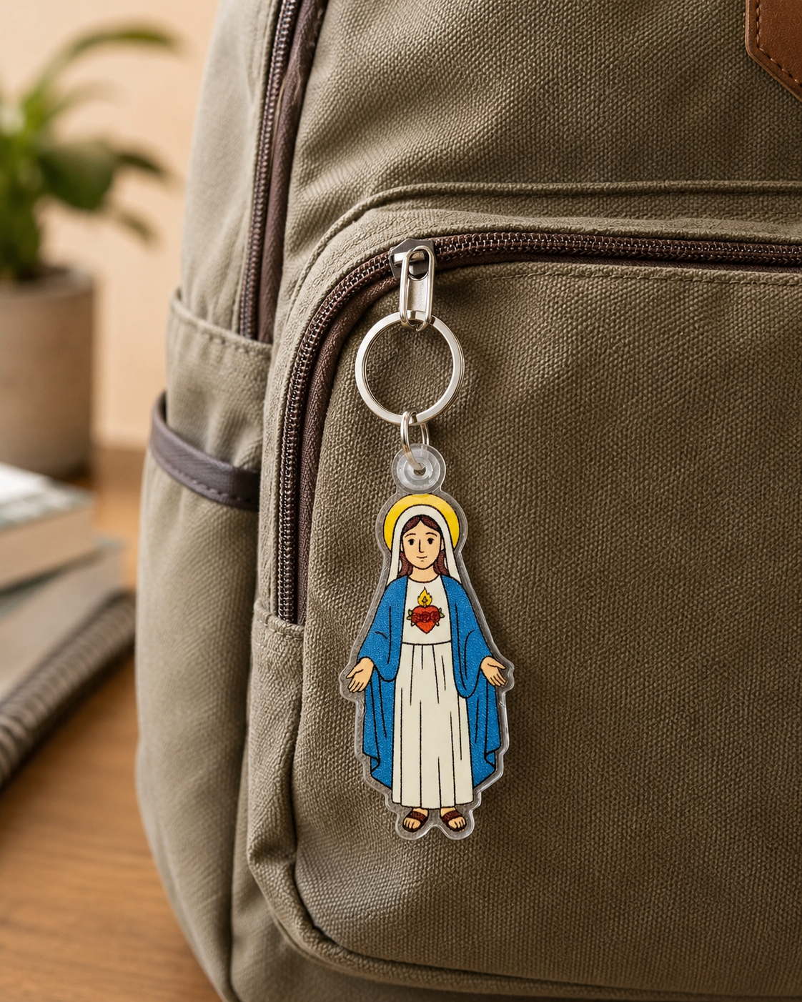 A die-cut acrylic keychain featuring a stylized illustration of the Immaculate Heart of Mary on a bookbag