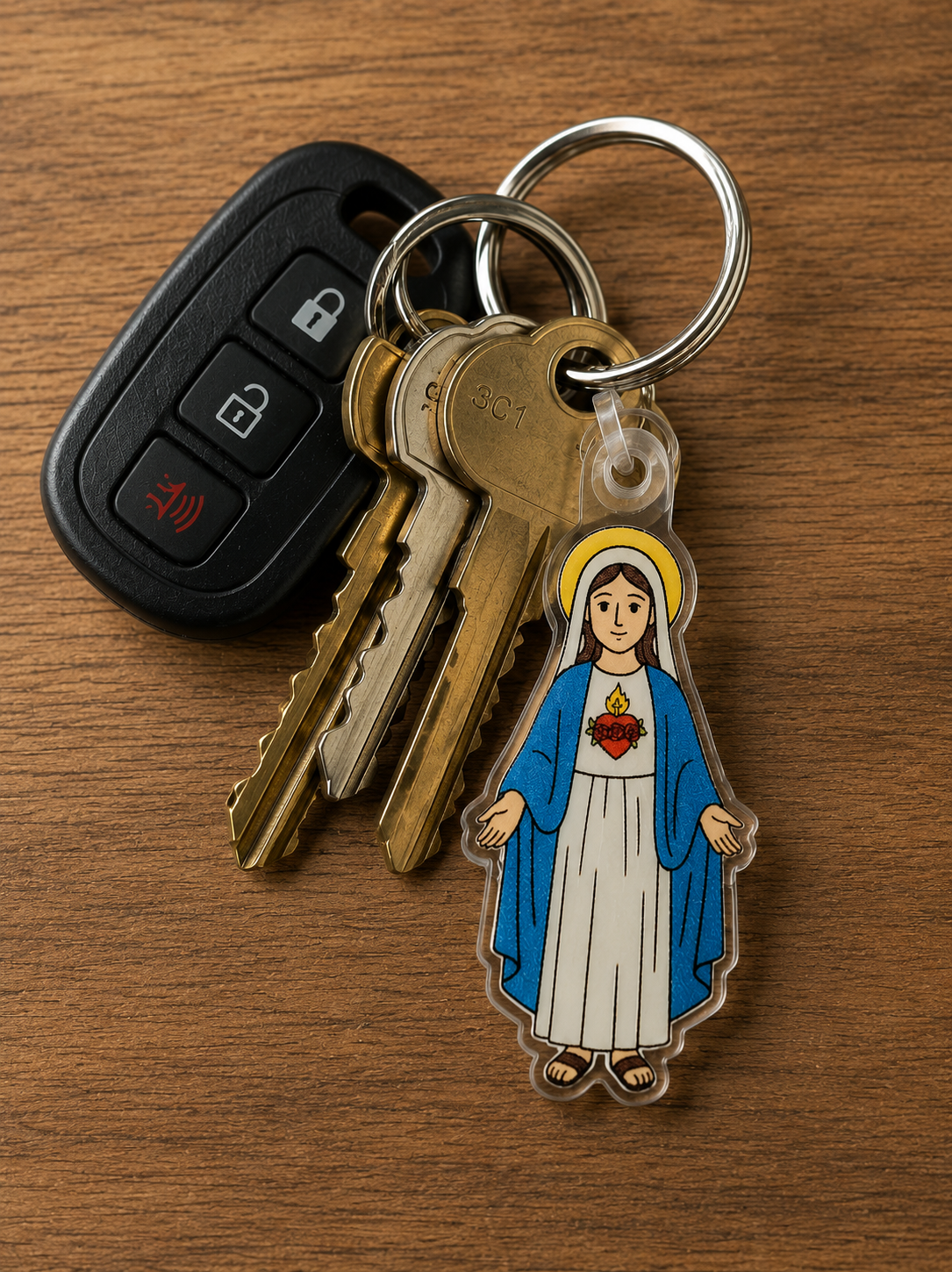 A die-cut acrylic keychain featuring a stylized illustration of the Immaculate Heart of Mary on a set of keys