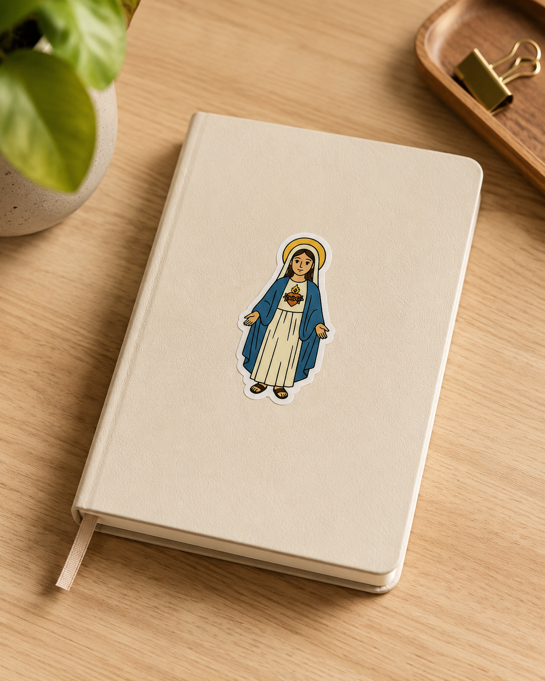 Immaculate Heart of Mary vinyl sticker on a notebook