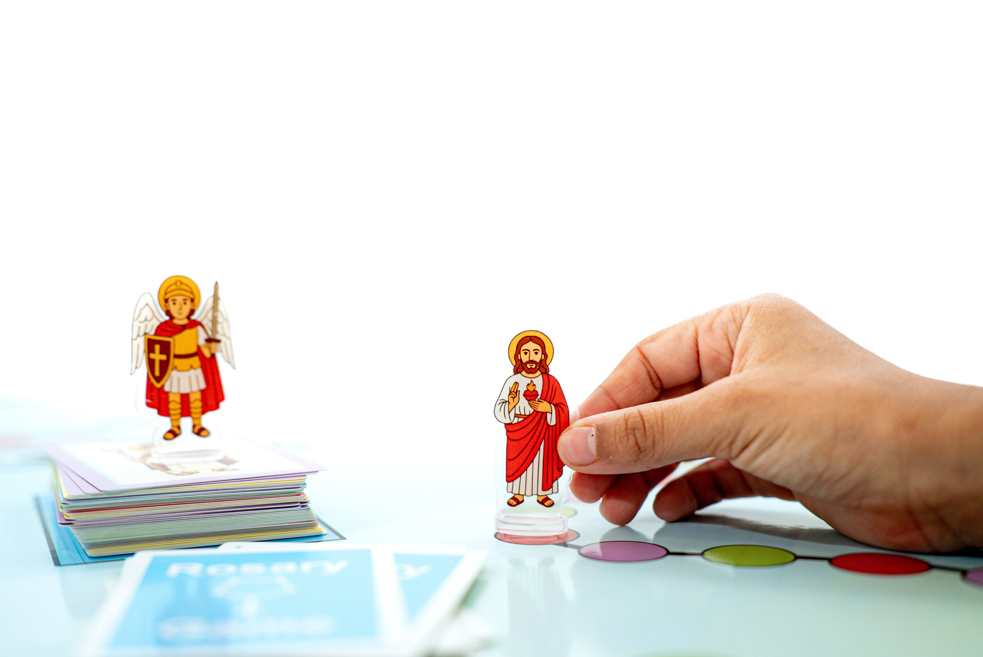 Acrylic saint figures included in the Rosary Game